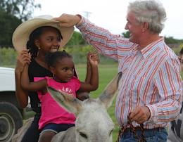 Stephen O'Dea leads Kye'ara and Ah'mya Verederber on a donkey ride. Stephen O'Dea leads Kye'ara and Ah'mya Verederber on a donkey ride.